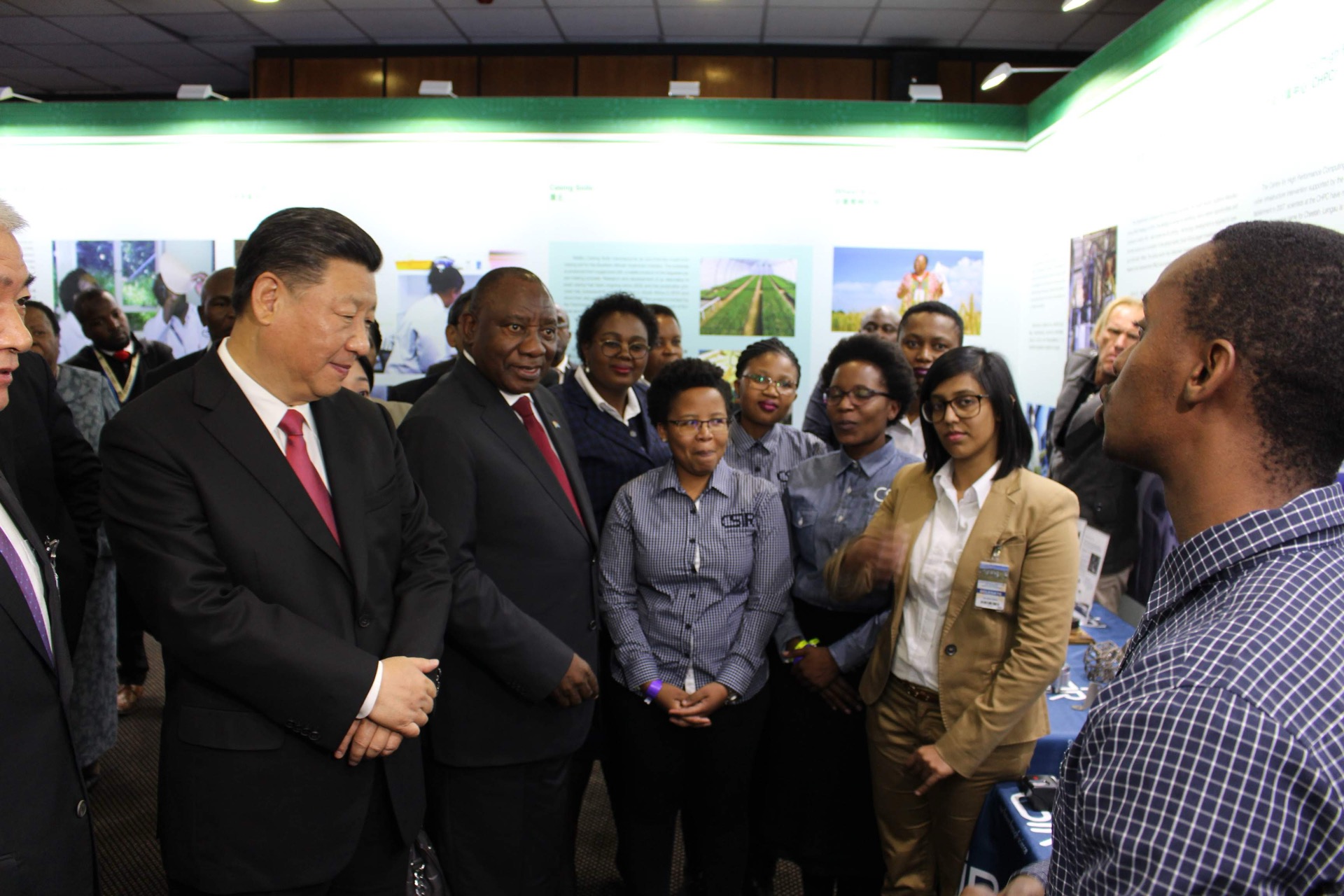 President Cyril Ramaphosa smiling during Thabang Mokoena's briefing while President Xi Jinping listens