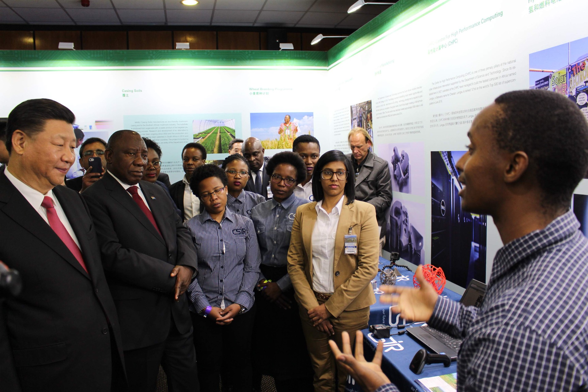 Thabang Mokoena speaking beside the CSIR technology display as Presidents Xi Jinping and Cyril Ramaphosa listen